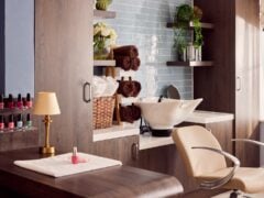 Modern beauty salon with nail polishes and sink.