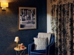A cosy corner of the private cinema room, setup for a resident to enjoy a drink and popcorn while watching their favourite film.