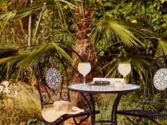 Garden table with lemonade and book.