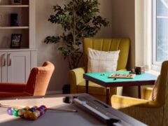 Cosy room with armchairs and board games.