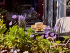 Garden seating with lavender, hat, and refreshments.