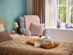 Cosy bedroom with breakfast tray on bed.
