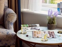 Cosy living room with checkers game and drinks.