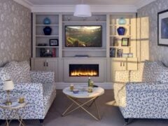 Cosy living room with fireplace and TV.