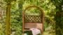 Wooden garden bench with cushion and throw blanket.