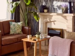 Cosy living room with sofas and fireplace.