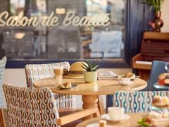 Cosy cafe with coffee, cakes, and decor.
