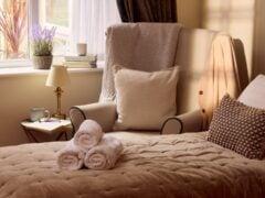 Cosy bedroom with armchair and soft furnishings.