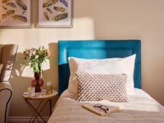 Cosy bedroom with decor and book on bed.