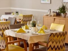 Elegant restaurant table with yellow napkins