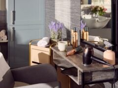 Modern salon setup with styling tools on table.