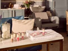 Salon table with beauty products and towels.