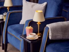 Cosy cinema seating with snacks and drinks.