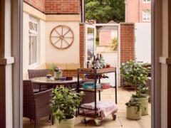 Cosy patio with drinks cart and plants.