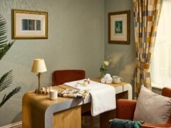 Cozy room with desk and wall art.