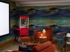 Cosy home cinema with popcorn machine and seating.