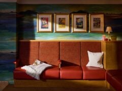 Cosy seating area with framed vintage posters.