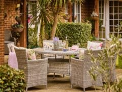 Cosy garden patio with rattan furniture and decor