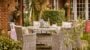 Cosy garden patio with rattan furniture and decor