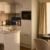 Modern kitchen with breakfast items on counter and table.