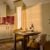 Cosy kitchen nook with wine on table.