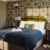Cosy bedroom with patterned wallpaper and plush bedding.