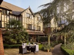 Charming Tudor-style building with outdoor seating area.