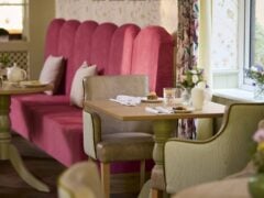Elegant café interior with vibrant pink seating.