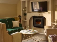 Cozy living room with fireplace and green sofa.
