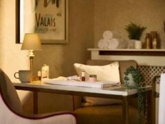 Cosy spa room with lamp and towels.
