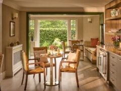 Elegant dining room with garden view and table settings.