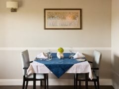 Elegant restaurant table setup for two with decor.