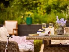 Outdoor seating with wine and lavender arrangement.