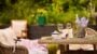 Outdoor seating with wine and lavender arrangement.