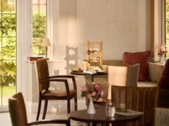 Cosy cafe with afternoon tea setup by window.