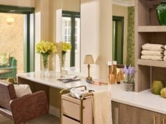 Elegant salon interior with chair and flowers.