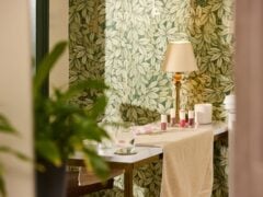 Cosy interior with lamp, plants, and table decor.