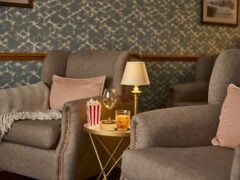 Cosy lounge with armchairs and drinks table.