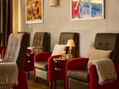 Cosy cinema lounge with comfortable chairs and lamps