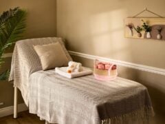 Relaxing spa room with massage bed and towels