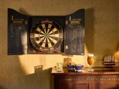 Dartboard above bar with drinks and snacks