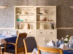 Cosy dining room with blue décor and cupboard