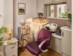 Modern hair salon with purple chair and sink