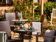 Outdoor table with tea and scones in garden