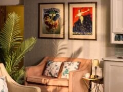 Cosy living room with pink sofa and wall art