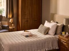 Cosy bedroom with neutral decor and wooden furniture