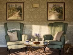 Cosy living room with green armchairs and table