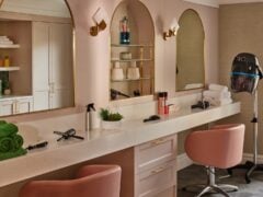 Modern beauty salon with mirrors and equipment.