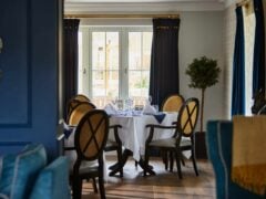 Elegant dining room with round table and chairs.