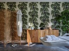 Spa room with tropical wallpaper and massage table.